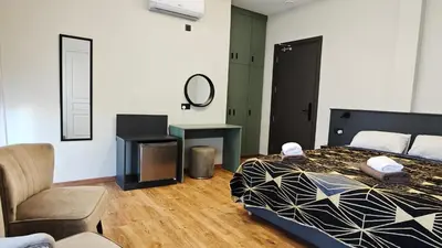 a bedroom with a bed and a chair and a mirror at St Lazarus City Hotel in Larnaka