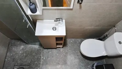 a bathroom with a white sink and a toilet at St Lazarus City Hotel in Larnaka