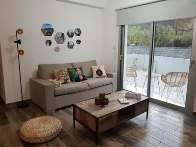 a living room with a couch and a coffee table at Evmelia Kakopetria Suites in Kakopetria