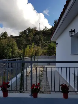 a balcony with potted plants and a view of a road at Evmelia Kakopetria Suites in Kakopetria