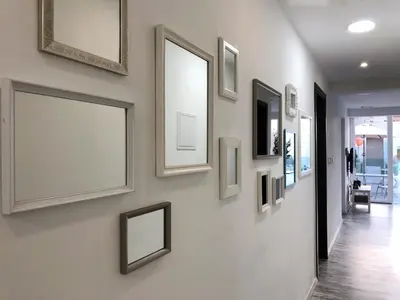 a hallway with framed pictures on a wall at Ayia Napa GO SEA Sunny Apt with Terrace 5 min to Beach in Ayia Napa