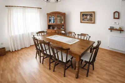 a dining room with a wooden table and chairs at Forest Park Villa in Lemithou