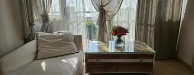 a glass table with a vase of flowers in a window at SeaView 6 Bedroom Villa & Private Pool in Limassol
