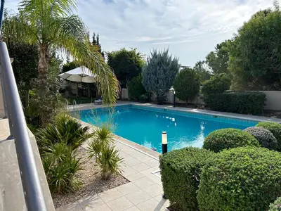 a swimming pool in a yard with trees and bushes at SeaView 6 Bedroom Villa & Private Pool in Limassol