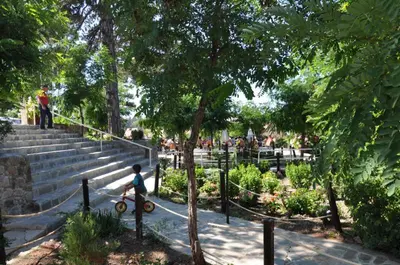 a young boy riding a bike in a park at Jubilee Hotel Troodos in Troodos