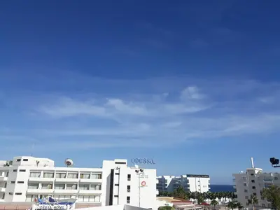 a white building with a sign on the side of it at FIG TREE GIANNIS in Protaras
