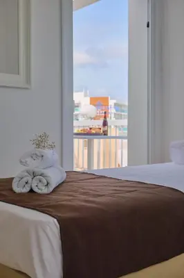 a bedroom with a bed with towels on it at FIG TREE GIANNIS in Protaras