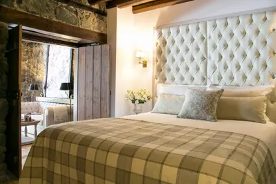 a bedroom with a large bed with a large headboard at Casale Panayiotis in Kalopanayiotis