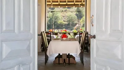 a dining room with a table with a white table cloth at Casale Panayiotis in Kalopanayiotis