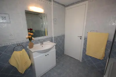 a bathroom with a sink and a mirror at Holidays Villas in Pissouri