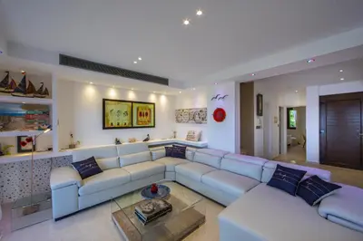 a living room with a couch and a table at Protaras El Greco Seafront Villa, Greco Mare in Protaras