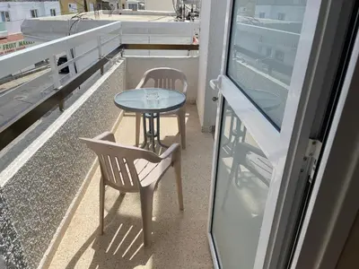 a table and chair on the balcony of a boat at Terpsithea Apartments in Ayia Napa