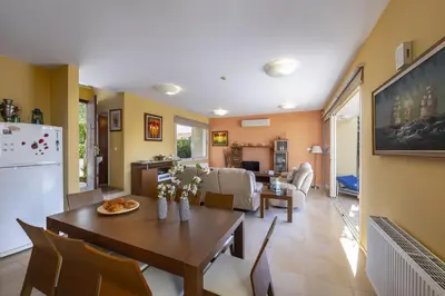 a kitchen and living room with a table and chairs at Larnaca Villa Anthea 12 in Larnaka