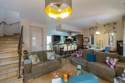 a living room with a couch and a table at Protaras Villa Rocco in Paralimni