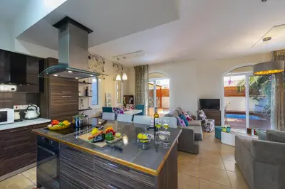 a kitchen and living room with a counter top at Protaras Villa Rocco in Paralimni