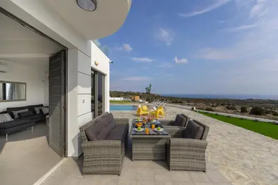 a patio with two couches and a table at Protaras Greco Hilltop Views in Protaras
