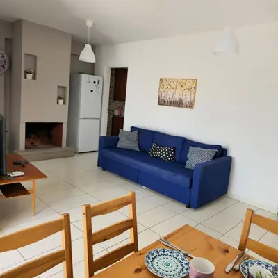 a living room with a blue couch and a table at Merab Holidays Apartments FA213 in Ayia Napa