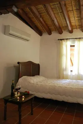 a bedroom with two beds and a table and a window at Xenis House in Galata