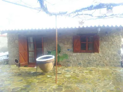 a toilet in front of a house with an umbrella at Xenis House in Galata