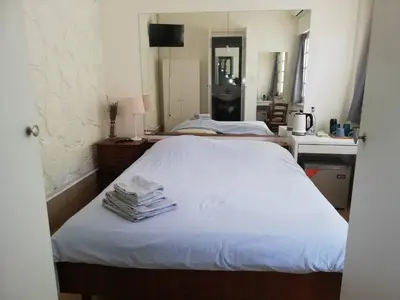 a bedroom with a bed with a stack of towels at Sparrows Nest in Larnaka