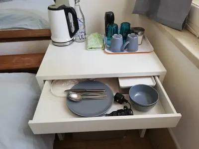 a white table with plates and utensils on it at Sparrows Nest in Larnaka