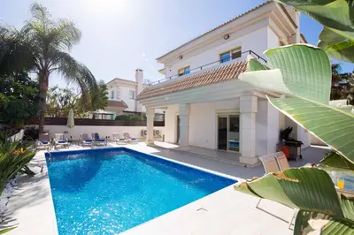 a swimming pool in front of a villa at Villa Malama in Paralimni