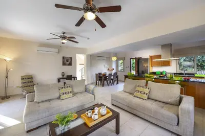 a living room with two couches and a kitchen at Villa Malama in Paralimni