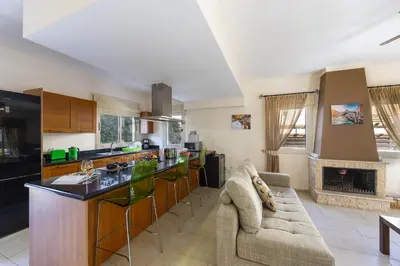 a kitchen and living room with a couch and a table at Villa Malama in Paralimni