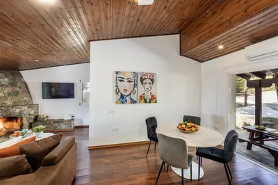 a living room with a table and a couch at Platres Forest View Cottage in Platres