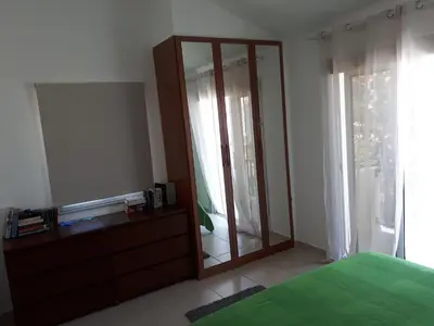 a bedroom with a dresser and a large mirror at Villa Bouboulina Cyprus in Ayia Napa