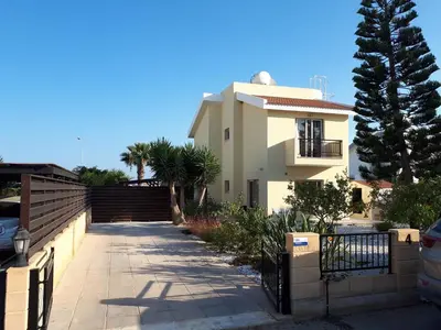 a white house with a fence in front of it at Villa Bouboulina Cyprus in Ayia Napa