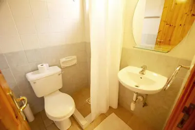 a bathroom with a toilet and a sink at Swimmers' Paradise in Pissouri