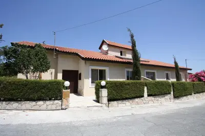 a house with a hedge in front of it at Swimmers' Paradise in Pissouri