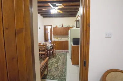 a kitchen and dining room with a ceiling fan at Iosiphis Stonebuilt House in Pano Lefkara