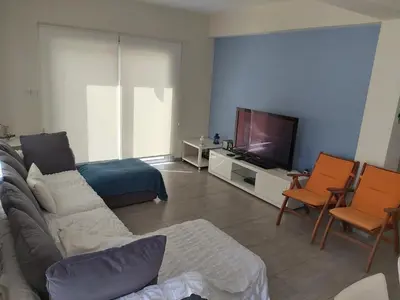 a living room with a couch and a tv at FAMILY HOME in Protaras