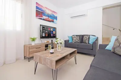 a living room with a couch and a table at Villa Eden in Ayia Napa