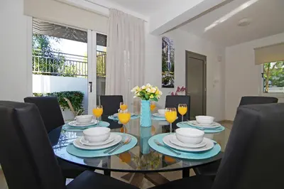 a dining room with a glass table and chairs at Villa Eden in Ayia Napa