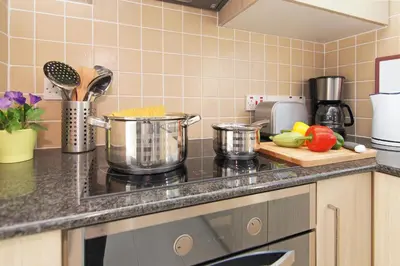 a kitchen counter with pots and vegetables on a cutting board at Villa Eden in Ayia Napa