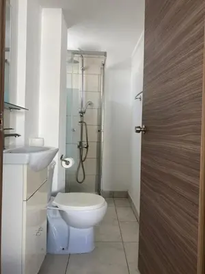 a bathroom with a toilet and a sink and a shower at Midtown Napa Apartments in Ayia Napa