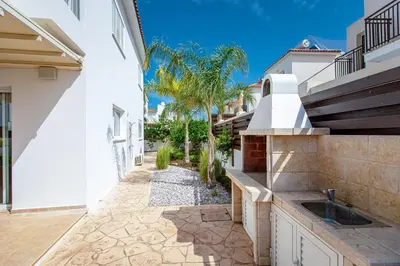 a kitchen in a house with a sink in a courtyard at Villa Nova in Protaras