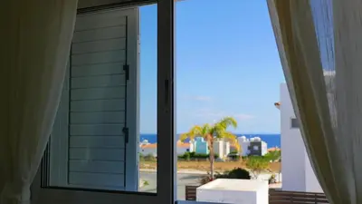 an open window with a view of the ocean at Villa Nova in Protaras