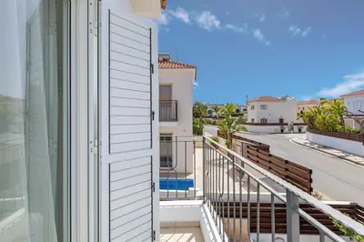 a balcony with a door and a view of a street at Villa Nova in Protaras