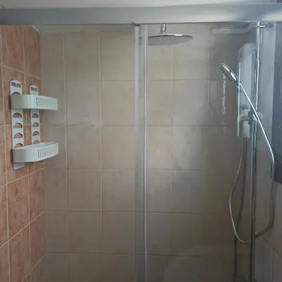 a bathroom with a shower with a glass door at Nicosia Luxury Studio in Nicosia