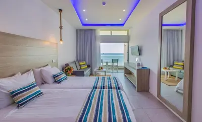 a hotel room with a bed and a view of the ocean at Island Boutique Hotel in Larnaka