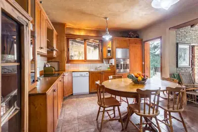 a kitchen with a table and chairs and a dining room at Kardama HideAway in Kato Amiandos