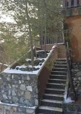 a set of stone stairs with snow on them at Kardama HideAway in Kato Amiandos