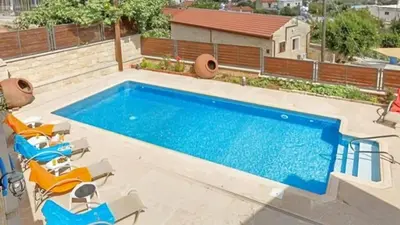 a swimming pool with lounge chairs and a swimming pool at Villa Elizabeth in Limassol