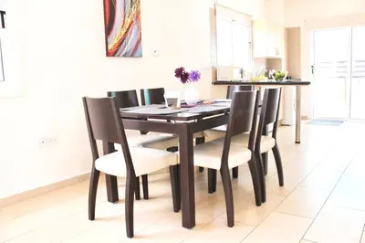 a dining room with a table and chairs at Villa Oceania in Ayia Napa
