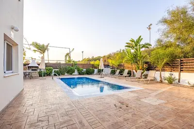 a swimming pool in the middle of a yard at Villa Oceania in Ayia Napa
