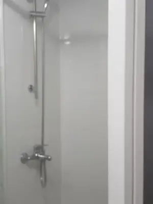 a shower in a bathroom with a glass door at City Large Studio in Limassol